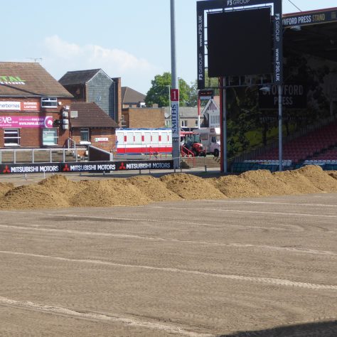 Piles of sand at the eastern end of the ground ready to be spread across the surface.