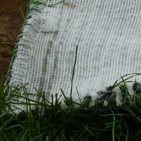 A closeup showing the stitching joining the two layers of mat together.
