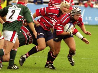 Taking on Leicester: Andy Hazell with the ball, supported by Jake Boer