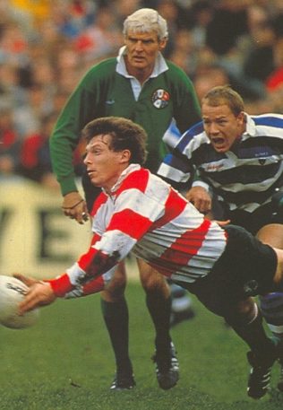 Cup semi-final 1989: Hannaford passes the ball out. Referee Roger Quittenton and Richard Hill of Bath look on.